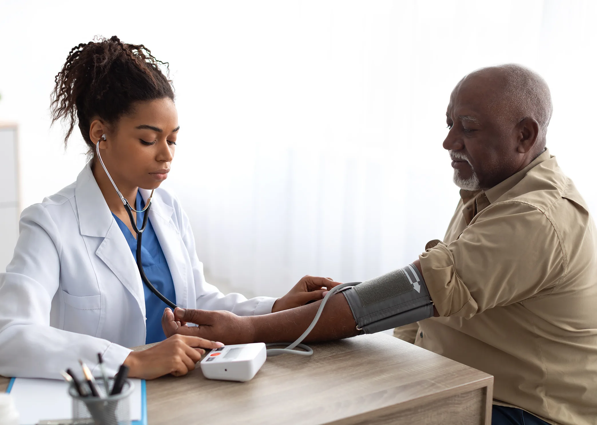 Black male being attended to by a Black healthcare worker