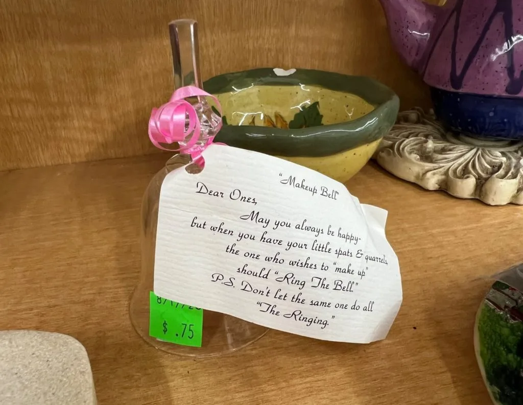 A small glass bell with a note attached, indicating that it's a 