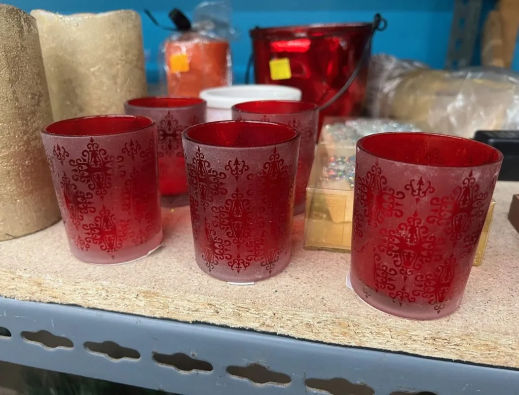 A collection of small frosted red candle holders.