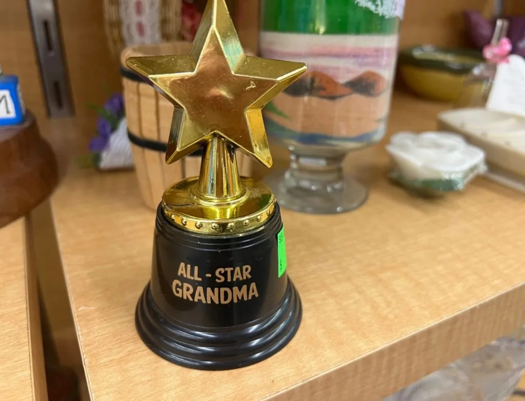 A small plastic star trophy that says All-Star Grandma on the base.