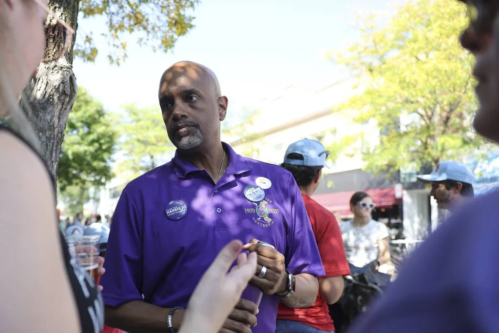 Clayton Harris III, a candidate for Cook County state's attorney, talks to visitors during Apple Fest in Lincoln Square on Sept. 30, 2023.