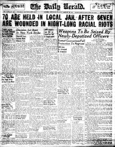 A newspaper headline says 70 people were jailed after a night long racial riot.