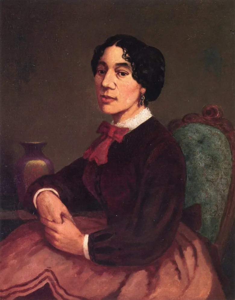 A portrait of a woman with folded hands. 