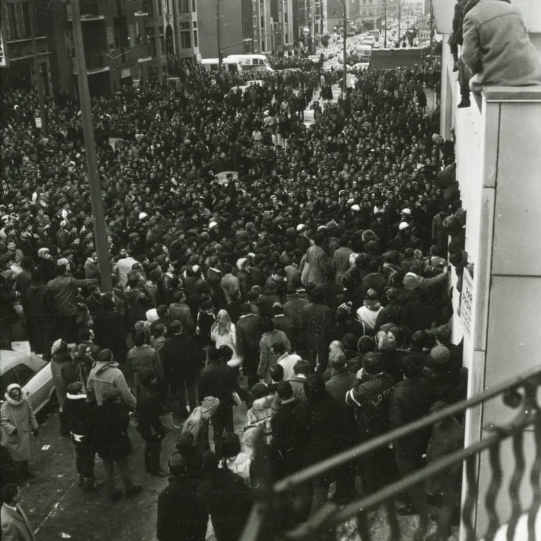 A large crowd fills the street.