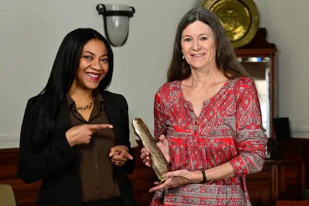 Katrina Miller and Beret Strong pose for a photo with the Boulder International Film Festival People's Choice Award for their documentary film 