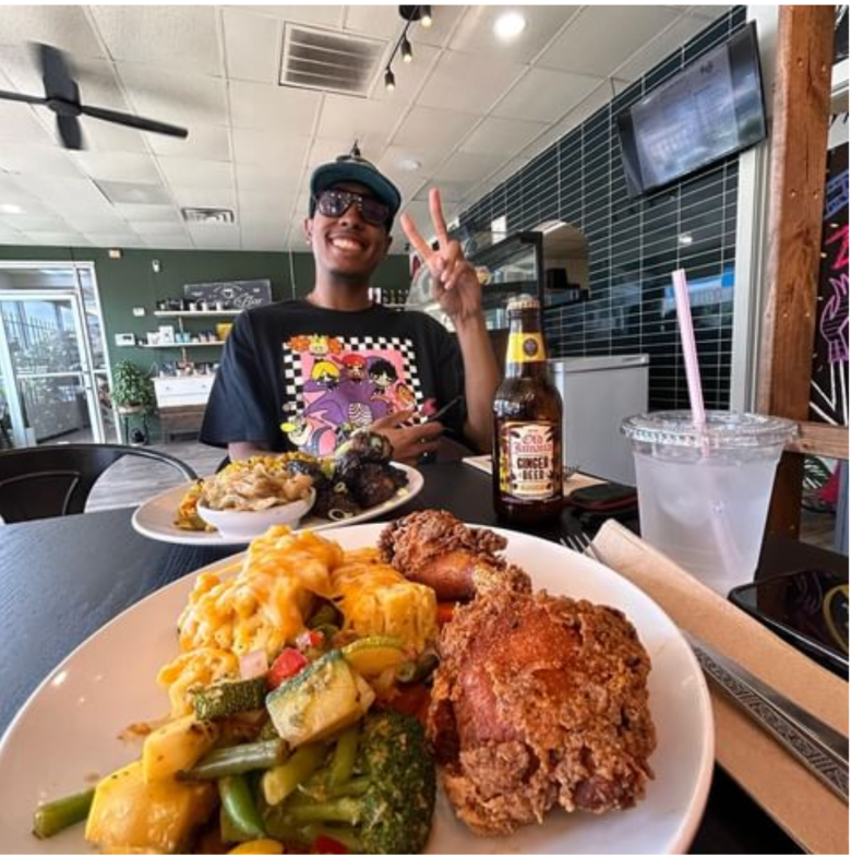 A customer enjoys Caribbean soul food from Kuji Kitchen. (Credit: Kuji Kitchen on Instagram)