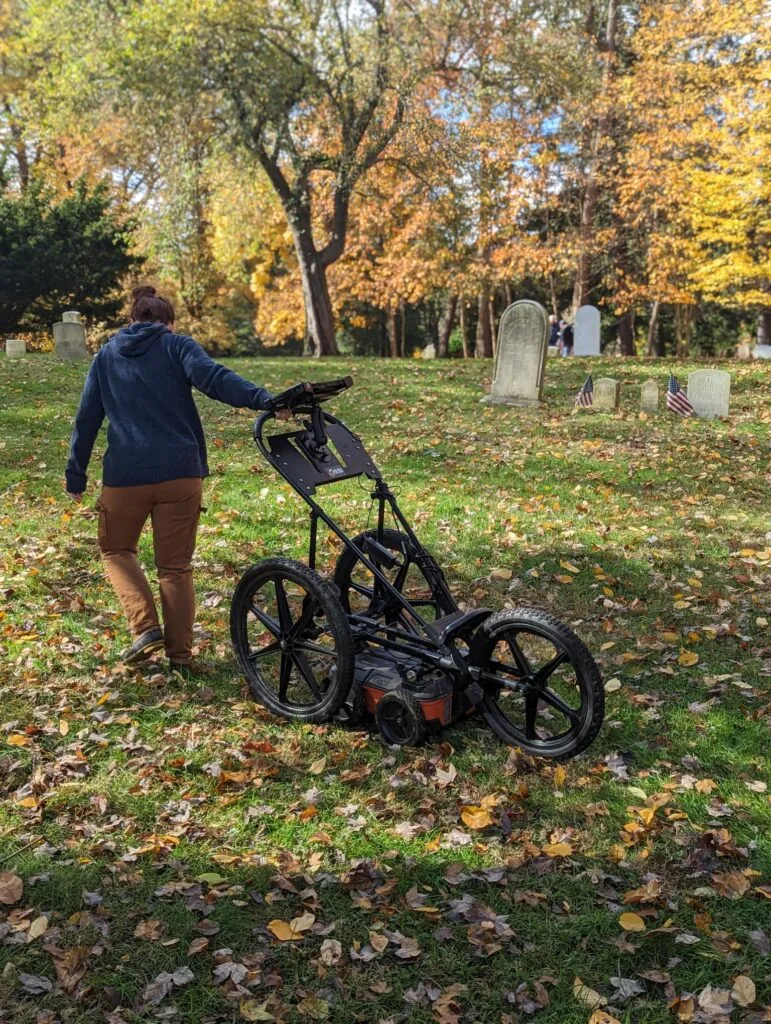 (PHOTO: Heritage Consultants uses what looks like a high tech baby stroller to map the underground at Rye's African American Cemetery.)