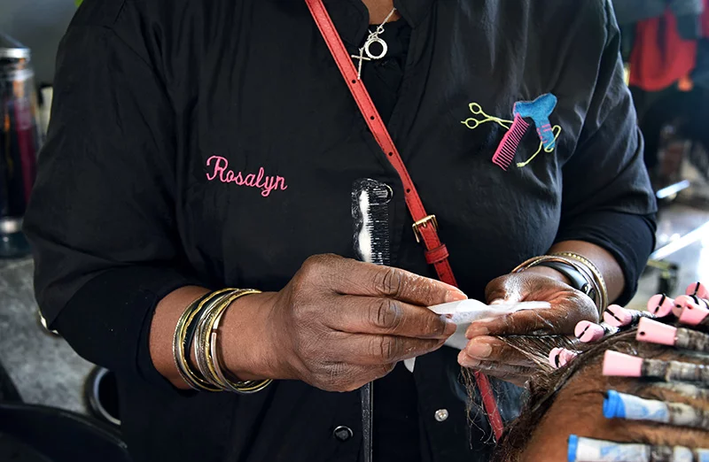 Salon owner Rosalyn Redwine applies permanent wave chemicals to Louise Anderson's hair, the first of 15 customers on a recent weekday. Louise said she has trusted only Rosalyn to style her hair for the past 30 years. Photo by Sonya Doctorian.