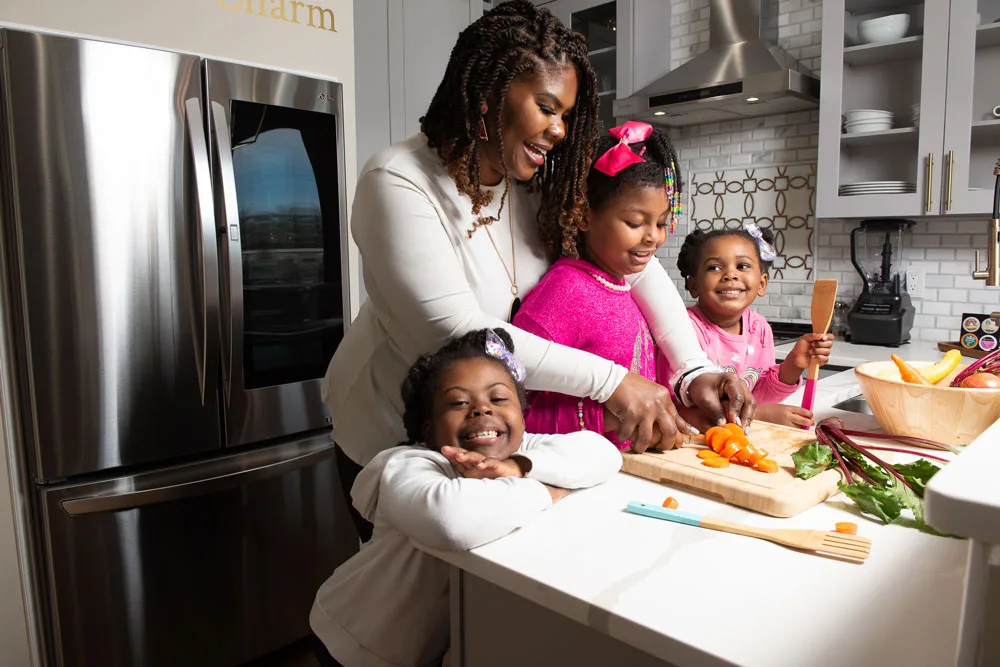 Dr. Cotwright and her three daughters prepare a healthy meal in the kitchen