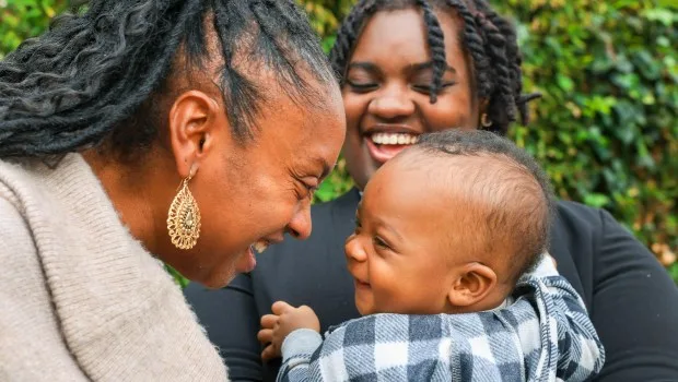 Hope Williams-Burt, left, plays with her 9-month-old grandson, Jeremyah, as her daughter Myrai Mills-Burt, 20, looks on at UCSF Benioff Claremont clinic in Oakland, Calif., on Friday, Jan. 26, 2024. Williams-Burt is a client at BLOOM: Black Baby Equity Clinic which provides care for Black families with babies and toddlers from a team of Black health care workers at the UCSF Benioff Claremont clinic. (Ray Chavez/Bay Area News Group)