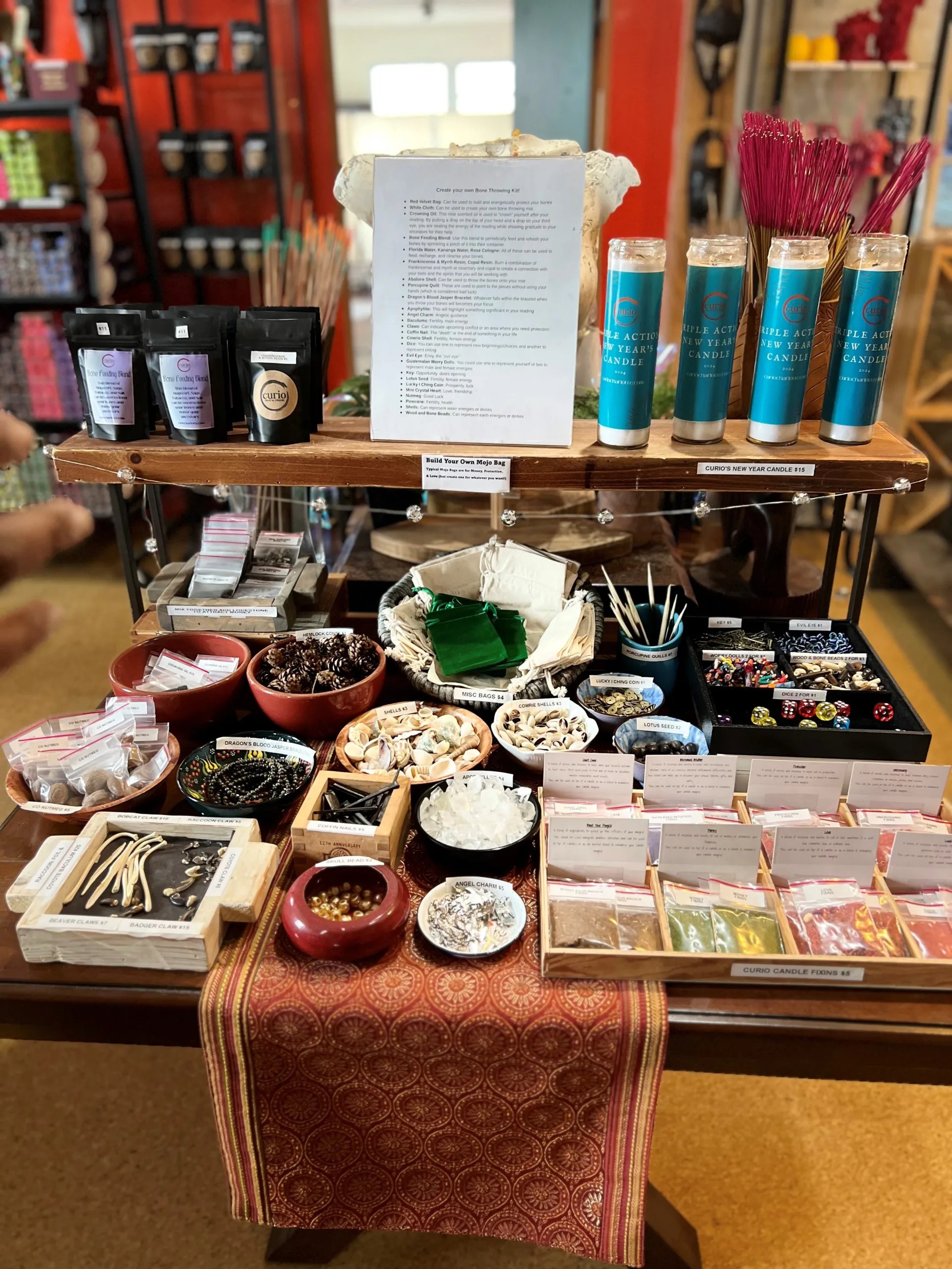 Various items on a display table inside Curio, Craft & Conjure.