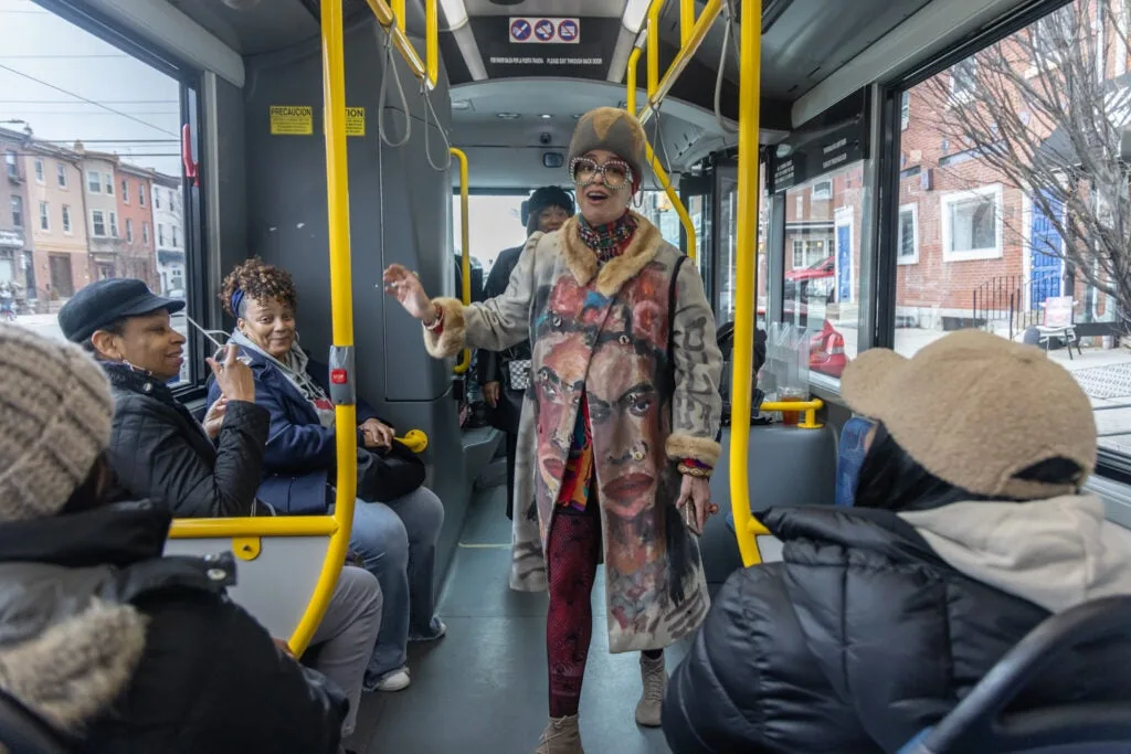 The Sisterhood Sit-In Trolley Tour’s guide, Starfire, speaks to tour-takers on the bus