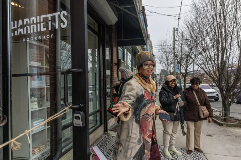 The Sisterhood Sit-In Trolley Tour’s guide, Starfire, welcomes participants to Harriet’s Bookshop in Philadelphia’s Fishtown neighborhood.