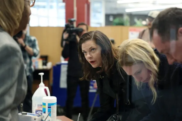 Cook County state's attorney candidate Eileen O'Neill Burke, center, with her daughter, Meredith, and husband, John, fill out paperwork before early voting at Dawson Technical Institute, 3901 S. State St. on Thursday, March 14, 2024, in Chicago. (John J. Kim/Chicago Tribune)