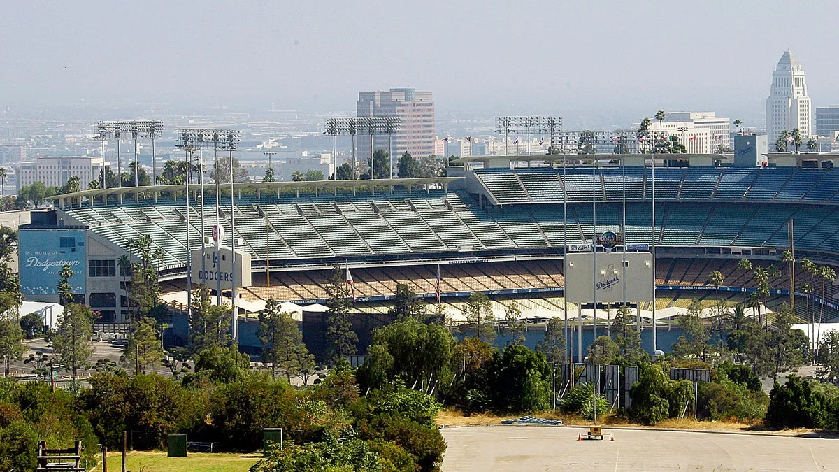 FILE - In this June 20, 2011, file photo, Dodger Stadium, home of baseball's Los Angeles Dodgers, with City Hall visible in right background. The Los Angeles Dodgers and Major League Baseball have agreed on a process to sell the team. In a joint statement released late Tuesday, Nov. 1, 2011, both sides say they have agreed 