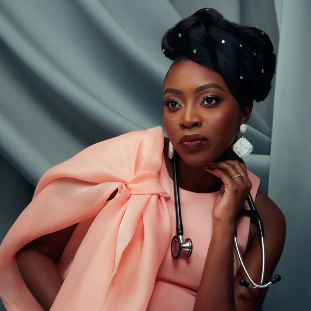 A portrait of Dr. Chika wearing a pink gown and a stethoscope