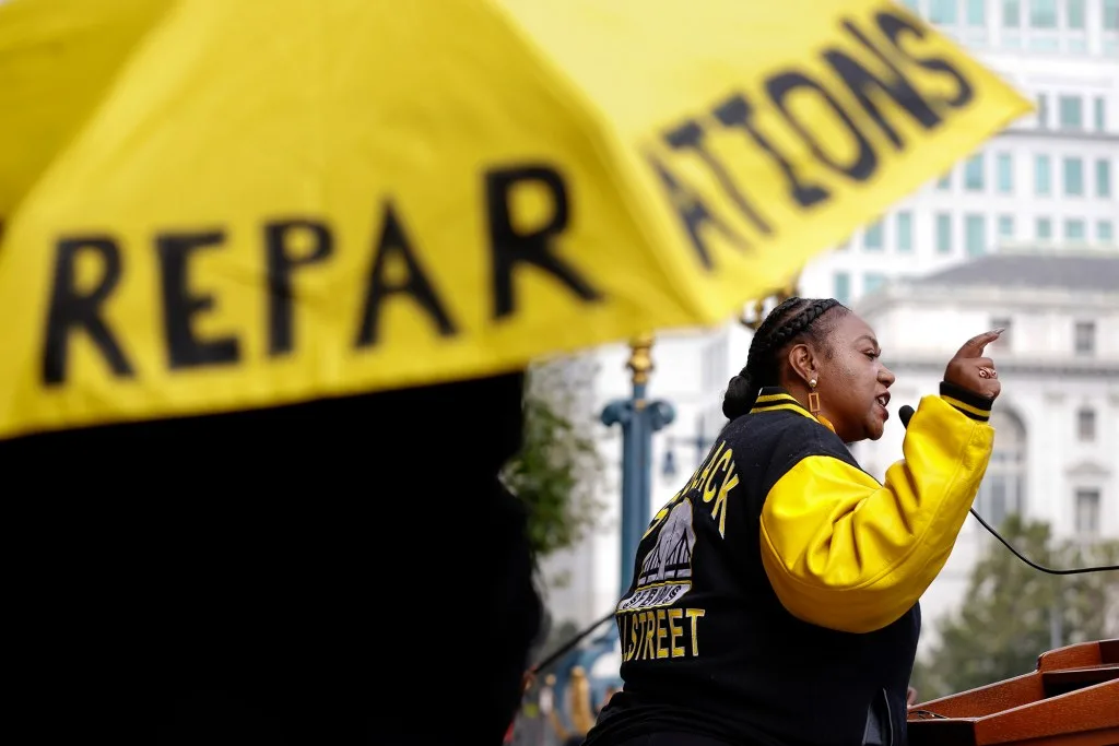 Tinisch Hollins, vice chair of the African American Reparations Advisory Committee, speaks to attendees at a rally in support of reparations in San Francisco in 2023. Photo by Lea Suzuki, San Francisco Chronicle via AP Photo