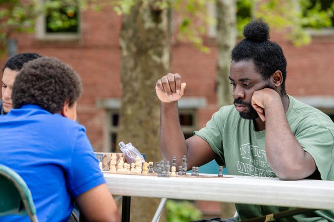 People play chess at the Community Reparations Jamboree at Pack Square Park in Asheville, April 27, 2024.