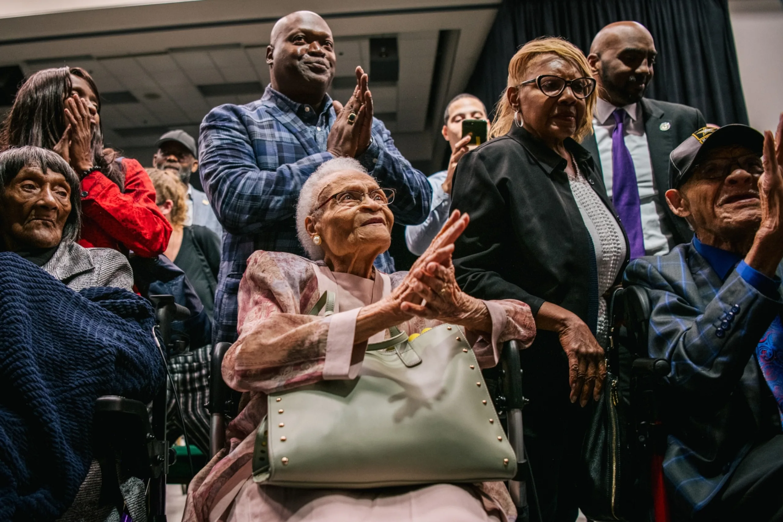 PHOTO: Survivors Lessie Benningfield Randle, Viola Fletcher, and Hughes Van Ellis sing together at the conclusion of a rally during commemorations of the 100th anniversary of the Tulsa Race Massacre on June 1, 2021, in Tulsa, Oklahoma.