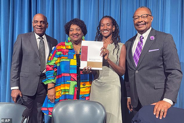 From left, State Sen. Steven Bradford, Secretary of State Shirley Weber, task force member Lisa Holder and Assemblymember Reggie Jones-Sawyer hold up a final report of the California reparations task force last year
