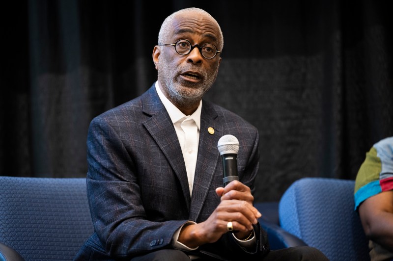 A speaker holding a microphone at Northeastern's 2024 Juneteenth Celebration.