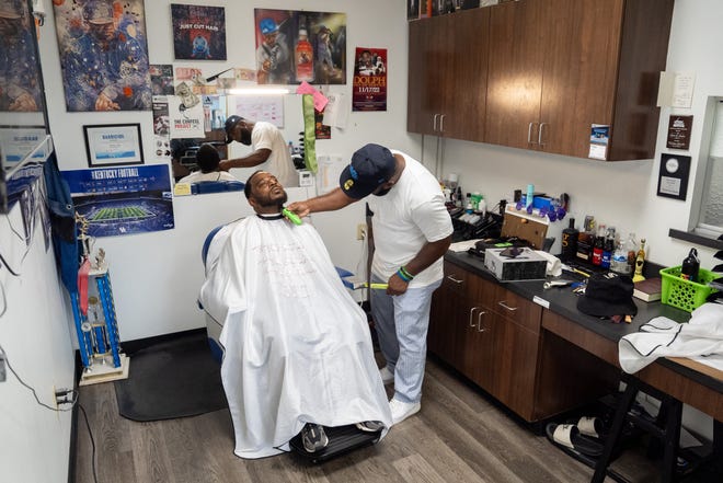 J. Divine Alexander cuts Eddie Dyre’s hair on Sunday, June 23, 2024, at The LAB Louisville, his barbershop in Louisville, Ky. Alexander, 50, is a participant in The Confess Project, a national mental health effort that trains barbers and stylists to be mental health advocates in Black communities, in which a longstanding stigma often surrounds mental health care. Such programs tap into the open conversation spaces that barbershops and salons create to address underlying issues and connect customers with resources when necessary.