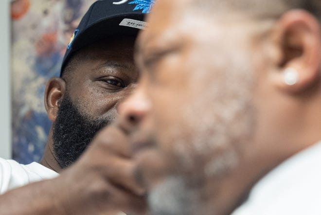 J. Divine Alexander cuts LaRon Williams' hair on Sunday, June 23, 2024, at his barbershop in Louisville, Ky. Alexander, 50, is a participant in The Confess Project, a national mental health effort that trains barbers and stylists to be mental health advocates in Black communities, in which a longstanding stigma often surrounds mental health care. Such programs tap into the open conversation spaces that barbershops and salons create to address underlying issues and connect customers with resources when necessary.