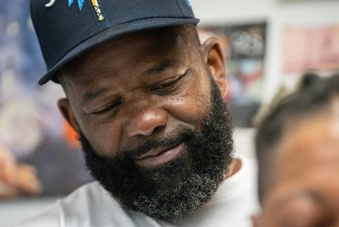 J. Divine Alexander cuts LaRon Williams' hair on Sunday, June 23, 2024, at The LAB Louisville in Louisville, Ky. Alexander, 50, is a participant in The Confess Project, a national mental health effort that trains barbers and stylists to be mental health advocates in Black communities, in which a longstanding stigma often surrounds mental health care. Such programs tap into the open conversation spaces that barbershops and salons create to address underlying issues and connect customers with resources when necessary.