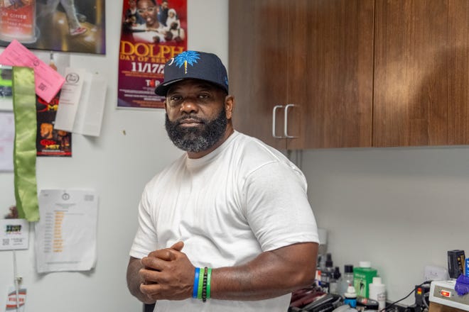 J. Divine Alexander poses for a portrait in his barbershop, The LAB Louisville Professional Barbering Services, on Sunday, June 23, 2024, in Louisville, Ky. Alexander, 50, is a participant in The Confess Project, a national mental health effort that trains barbers and stylists to be mental health advocates in Black communities, in which a longstanding stigma often surrounds mental health care. Such programs tap into the open conversation spaces that barbershops and salons create to address underlying issues and connect customers with resources when necessary.