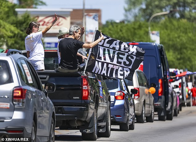 Drivers wave a Black Lives Matter flag in 2021