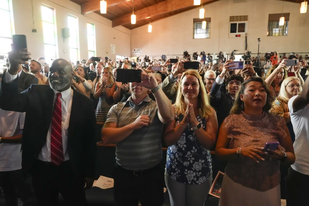 People watch as Republican presidential candidate former President Donald Trump arrives at a campaign event at 180 Church, Saturday, June 15, 2024, in Detroit. (AP Photo/Carlos Osorio)