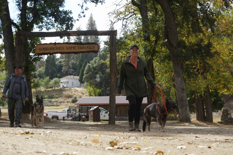 People walk through Marshall Gold Discovery State Historic Park, Tuesday, Oct. 10, 2023, in Coloma, Calif. (AP Photo/Godofredo A. Vásquez)