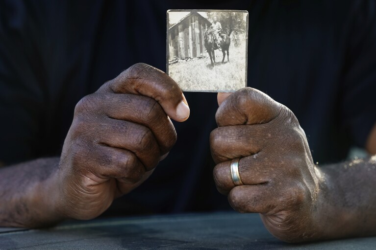 Matthew Burgess holds a photograph of his grandfather Rufus Morgan Burgess Jr., Monday, Oct. 9, 2023, in Sacramento, Calif. (AP Photo/Godofredo A. Vásquez)