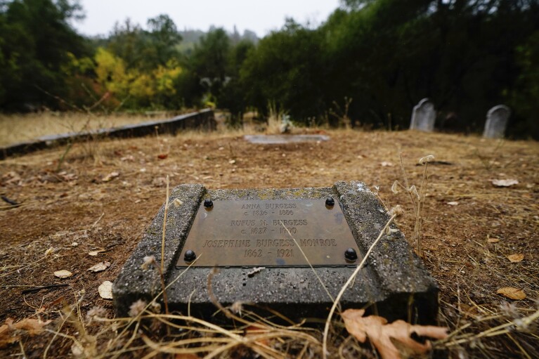 A tombstone for ancestors of the Burgess family is seen at the Marshall Gold Discovery State Historic Park cemetery Tuesday, Oct. 10, 2023, in Coloma, Calif. (AP Photo/Godofredo A. Vásquez)