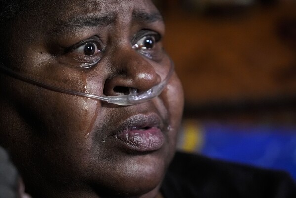 Shelia Mae Dobbins cries as she talks about her health inside her home in Gloster, Miss., Wednesday, May 29, 2024. Dobbins feels her life — and health — were better before Drax began compressing tons of wood chips nearby. (AP Photo/Gerald Herbert)