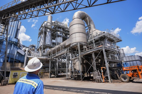 Dan Caston, an employee of Drax leads a tour of their plant in Gloster, Miss., Monday, May 20, 2024. Wood pellet production skyrocketed across the U.S. South to feed the European Union's push this past decade for renewable energy to replace fossil fuels like coal. (AP Photo/Gerald Herbert)