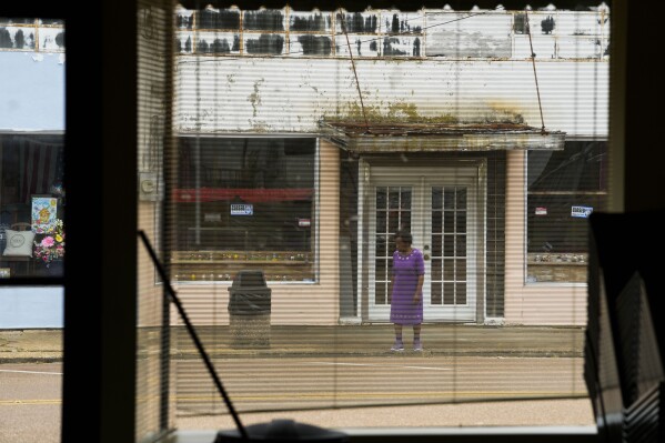 A resident crosses the street for a community meeting regarding health complaints against Drax in Gloster, Miss., Thursday, May 2, 2024. (AP Photo/Gerald Herbert)