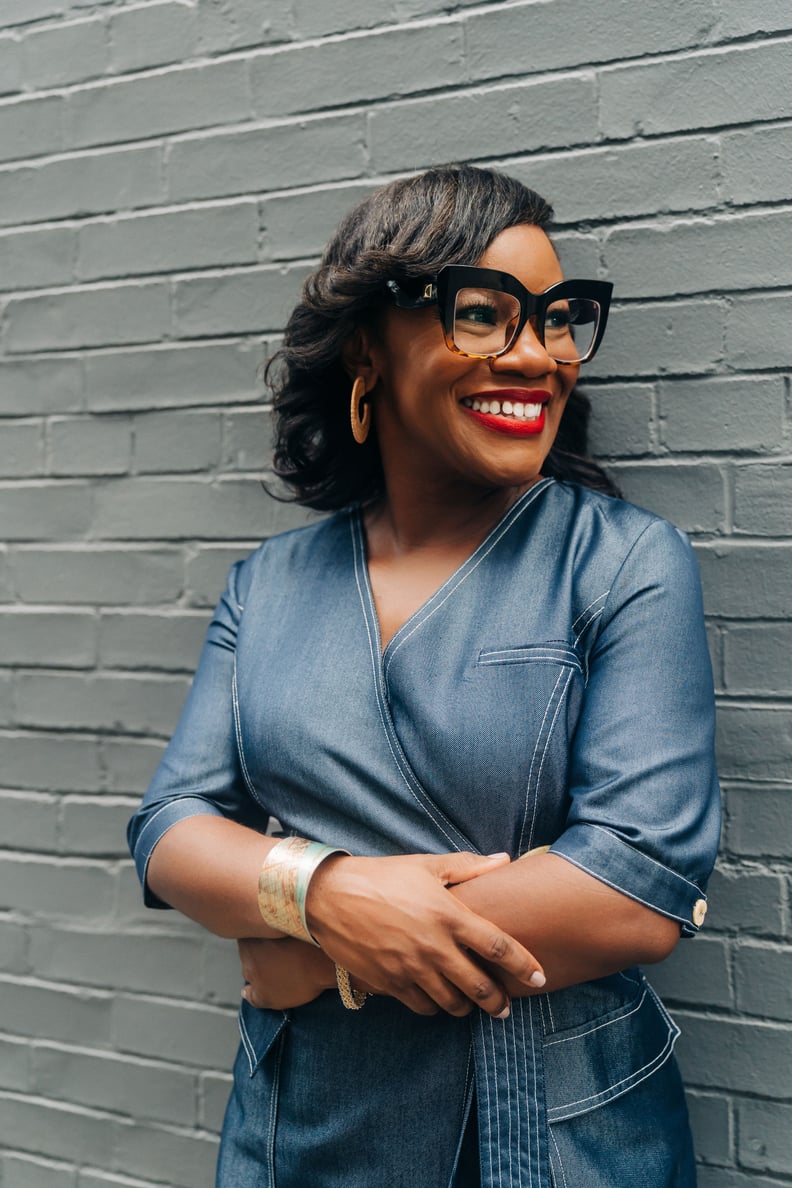 A photo shows Kimberly Seals Allers smiling in front of a brick background.