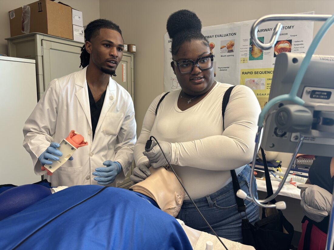 Jerrian Reedy (left), a student at the University of Mississippi School of Medicine, assists Dorothy Gray, a student at Northside High School in the Mississippi Delta, as she practices intubation in a simulation lab. Gray, who is interested in pursuing a career in the mental health care field, attended the University of Mississippi School of Medicine’s annual African American Visit Day in April.