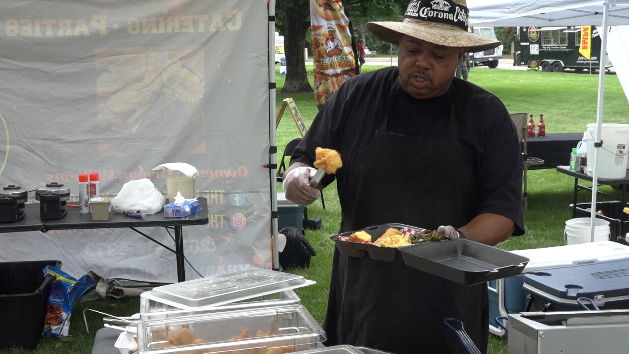 Yharman Williams loads a plate with soul food