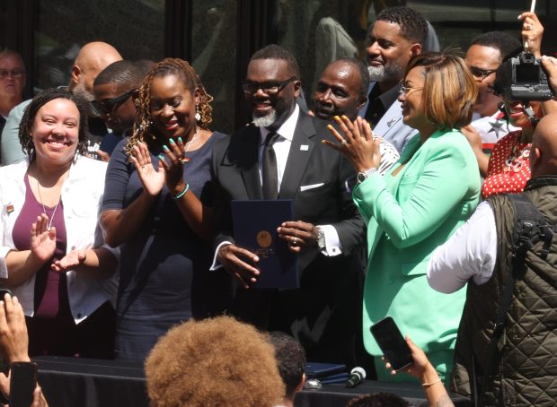 People clap as Chicago Mayor Brandon Johnson touts the creation of a Reparations Task Force to develop a Black Reparations Agenda during a Juneteenth Flag Raising Ceremony at Daley Plaza on Monday, June 17, 2024. (Antonio Perez/Chicago Tribune)