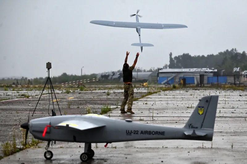 A military operator launches a FlyEye WB Electronics SA, a Polish reconnaissance drone, during test flights in the Kyiv region of Ukraine on Aug. 2, 2022.