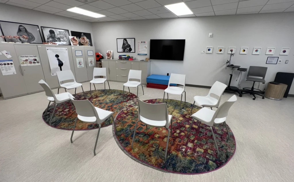 Chairs sit in a circle in a room at Five Rivers.