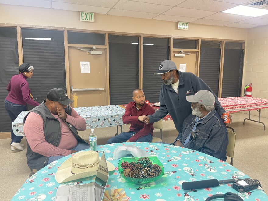 As people say their goodbyes, Celano Jones (left) sit with Kristopher Harvey, mayor of the Town of Tatums, and fellow producer Park Prince.