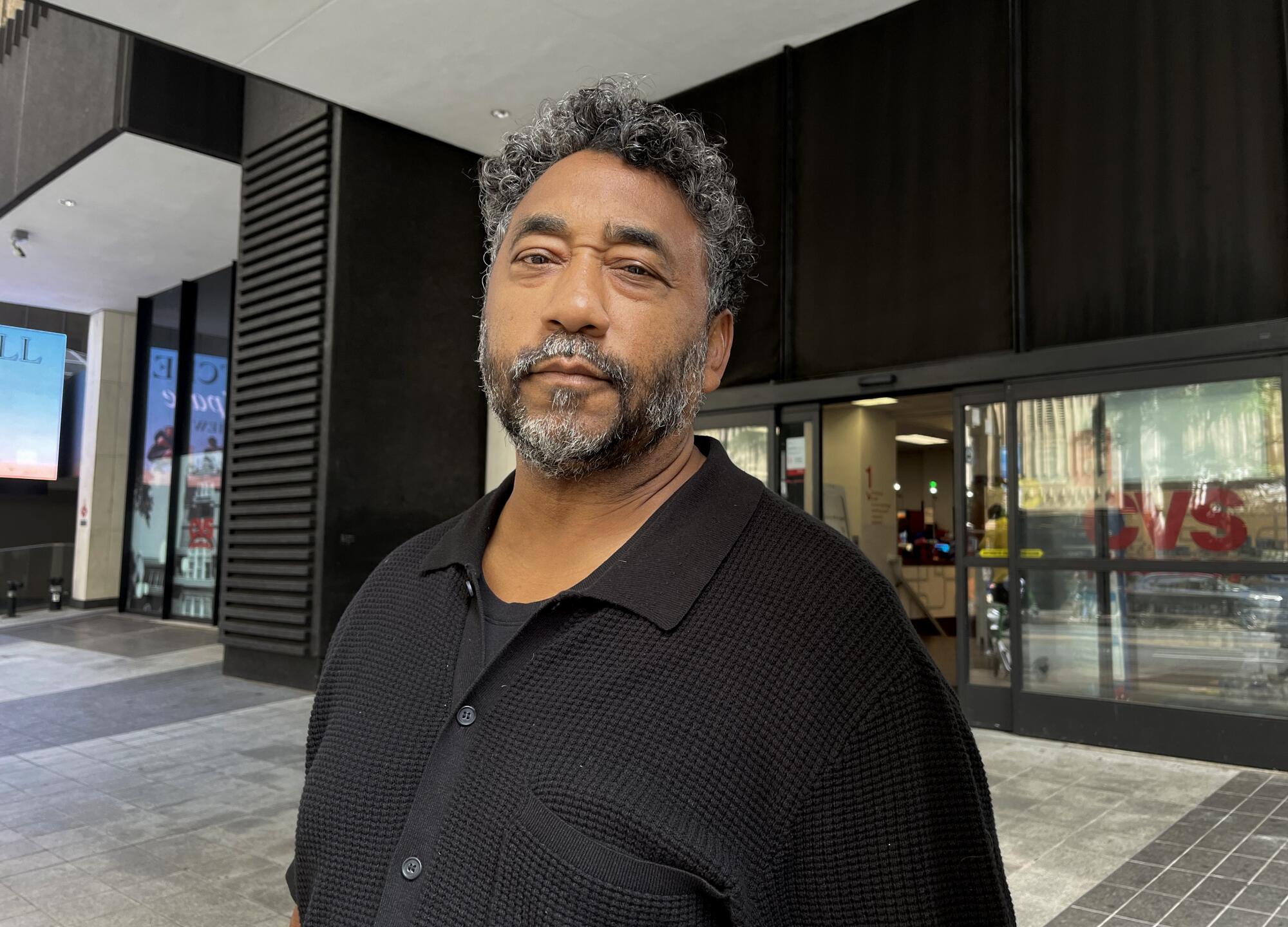 Robert Mitchell standing on a sidewalk outside a CVS pharmacy in Atlanta