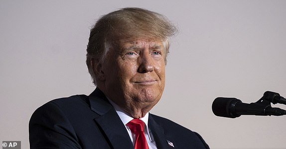 FILE - Former President Donald Trump speaks during a rally in Perry, Ga., on Sept. 25, 2021. As Trump's lawyers try to block the White House from releasing records to the congressional committee investigating the Jan. 6 Capitol insurrection, the former president faces a flurry of other investigations that could come to a head in the coming weeks and the new year. That includes two major state criminal investigations â¿