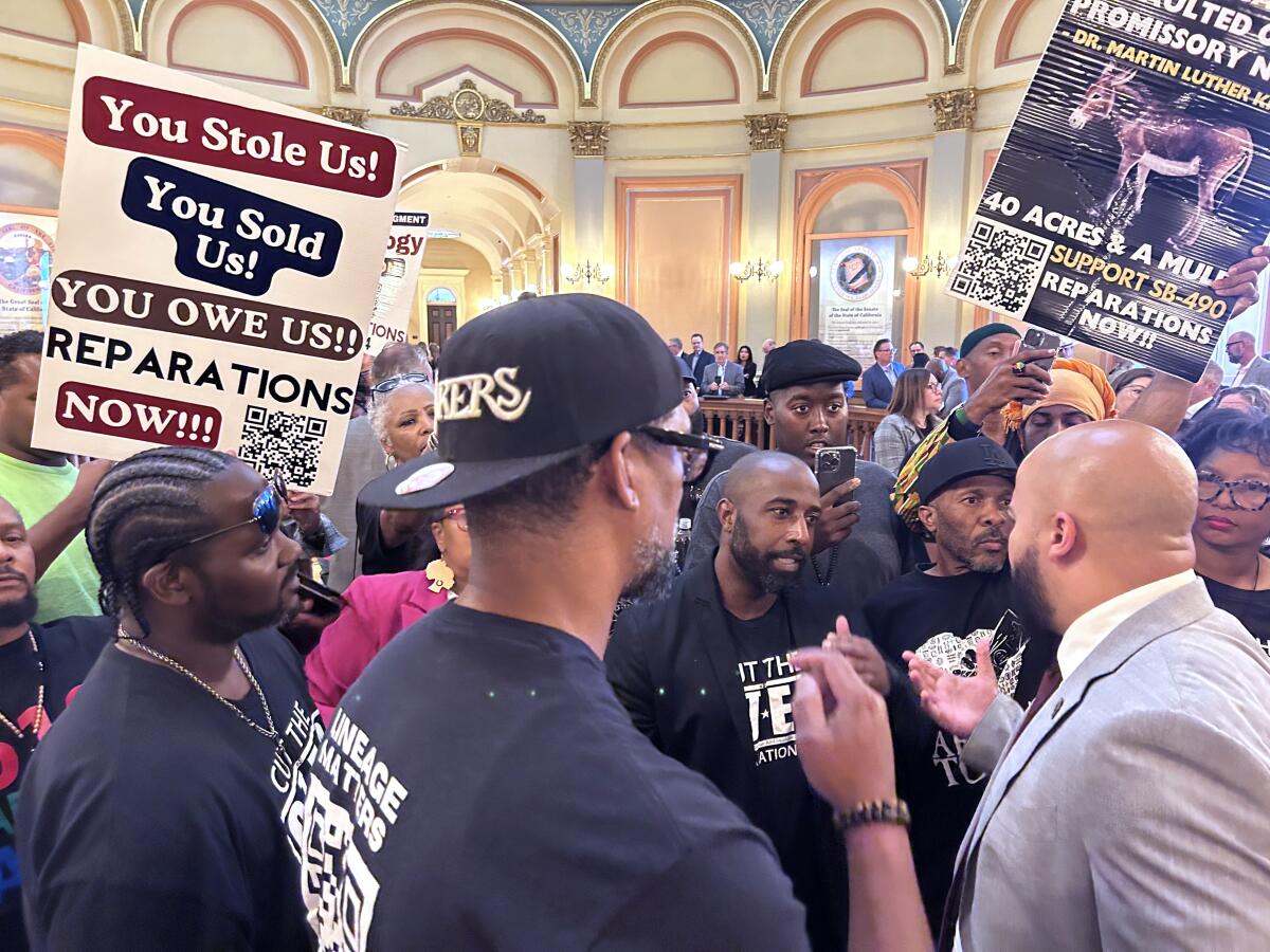 Protesters surround a man.