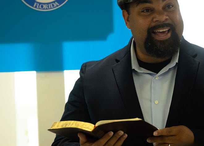 Jesse L. Nelson, pastor of Macedonia Missionary Baptist Church in Panama City, Fla., reads from the Bible prior to the unveiling of small business historical markers Sept. 14, 2024. The markers showcase the legacy of entrepreneurship and community spirit that defines the city’s Glenwood neighborhood. (Tyler Orsburn/News Herald)