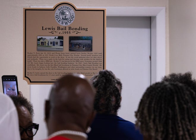 Friends and family gather around the Lewis Bail Bonding historical marker at Macedonia Missionary Baptist Church in Panama City, Fla., Sept. 14, 2024. The marker showcases the legacy of entrepreneurship and community spirit that defines the city’s Glenwood neighborhood. (Tyler Orsburn/News Herald)