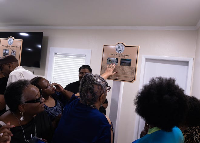 Friends and family gather around the Lewis Bail Bonding historical marker at Macedonia Missionary Baptist Church in Panama City, Fla., Sept. 14, 2024. The marker showcases the legacy of entrepreneurship and community spirit that defines the city’s Glenwood neighborhood. (Tyler Orsburn/News Herald)